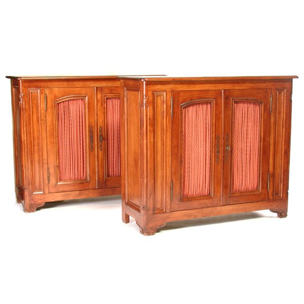 Pair Of Custom Made French Style Cabinets: CREDENZAS. Pair of custom made French style credenzas having carved and fluted corners and molded panels, with wire mesh panel double doors lined with salmon pink silk, rising on carved bracket feet,