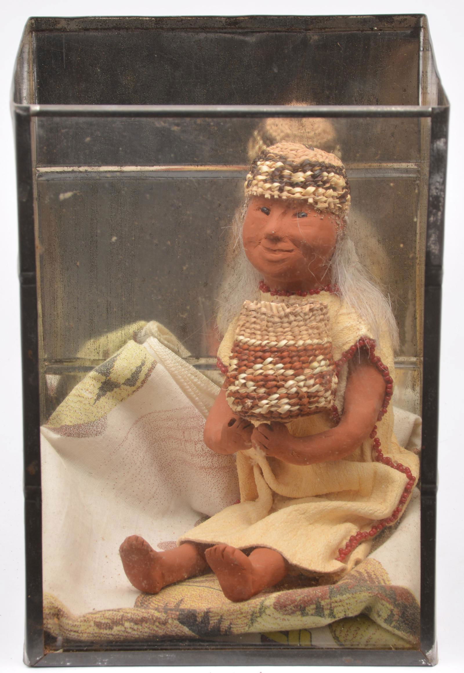 Yurok Native American grandma doll: Yurok Native American grandma doll with blanket and basket, cased, Doll is 5 1/2" tall seated. Case: 7 1/4" x 5 1/4" x 5"