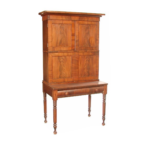 American Plantation Desk: DESK. American plantation desk having molded cornice, double doors above drop front desk revealing interior fitted stationery compartments, the drop front writing surface lined with blue and white fol