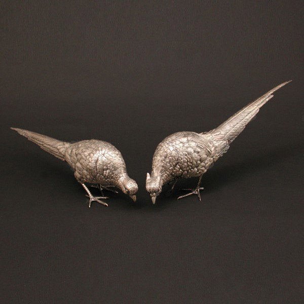 Pair of 800 Silver Pheasant Table Ornaments: SILVER. Pair of Continental 800 silver table ornaments in the form of pheasants with molded cast feathers, claws, and beak, 27.3 ozt, 15"L.