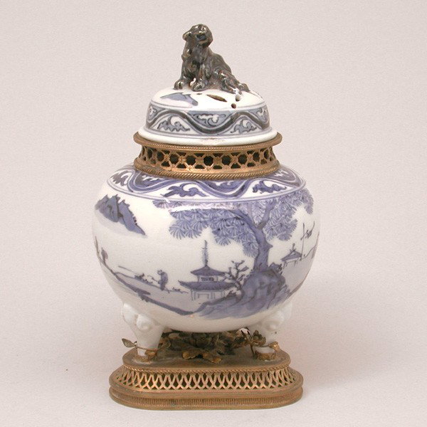 Chinese Potpourri Container with Ormolu, 19th Cent: CONTAINER. Chinese 19th century blue and white incense burner converted to potpourri container with ormolu, on three legs with scenic designs, covered with shishi dog knob and added ormolu mounts, 4 1