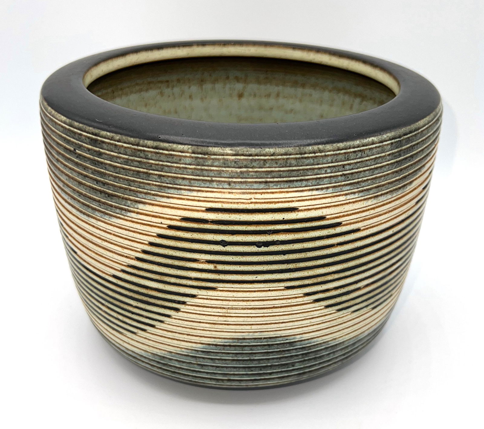 Harrison McIntosh Stoneware Bowl: Harrison McIntosh Stoneware Bowl with impressed "HM" signature. Retains original label and #76273. Lineal multi-color ribbed decoration. Appx. 5 1/2"t x 7 3/8"d. Very good condition.