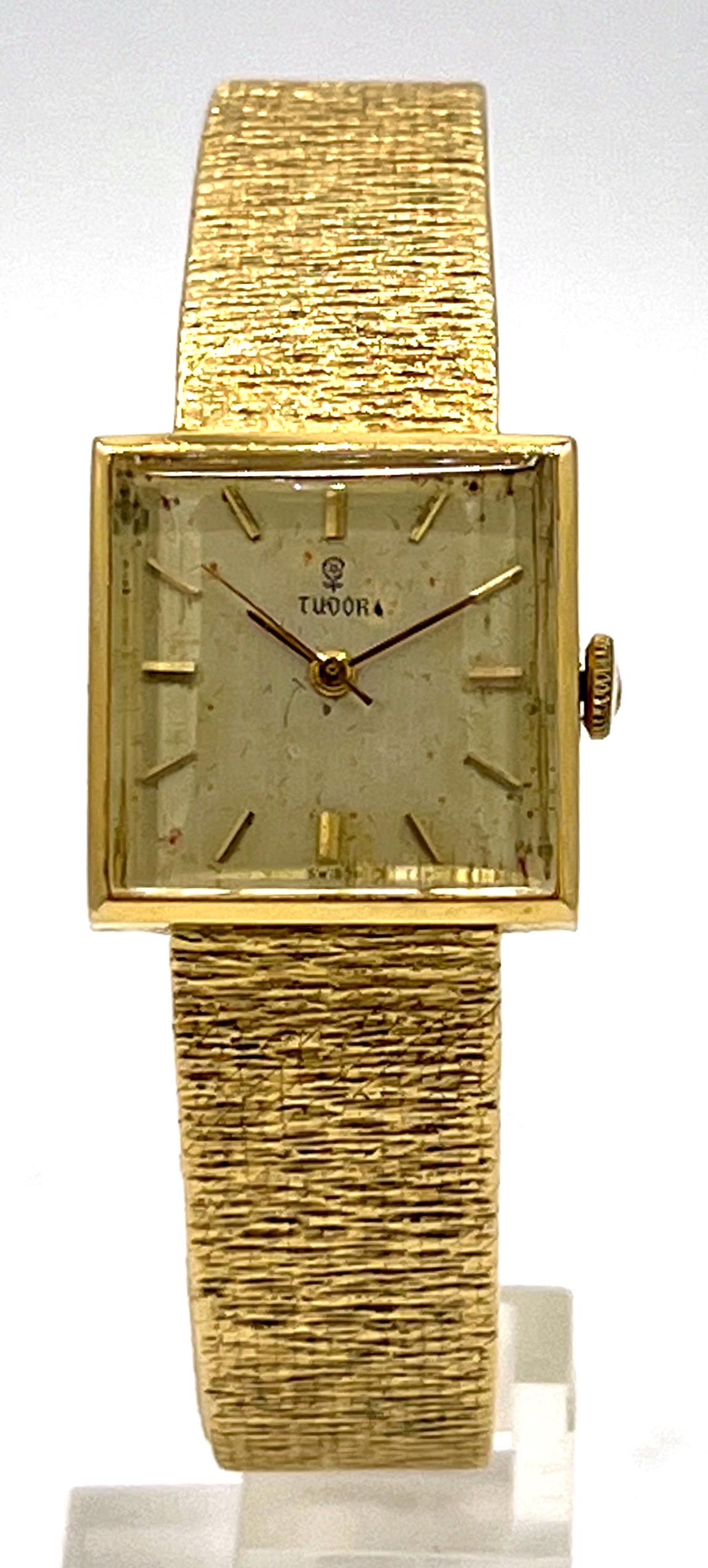Ladies Tudor 18kyg Wristwatch, square dial & "bark" band.: Ladies Tudor 18kyg Wristwatch with square dial and "bark" band. Manual wind. Appx 7" long. Dial measures appx 3/4" x 3/4". Running. Soiled dial as shown. Gross weight 47.36g