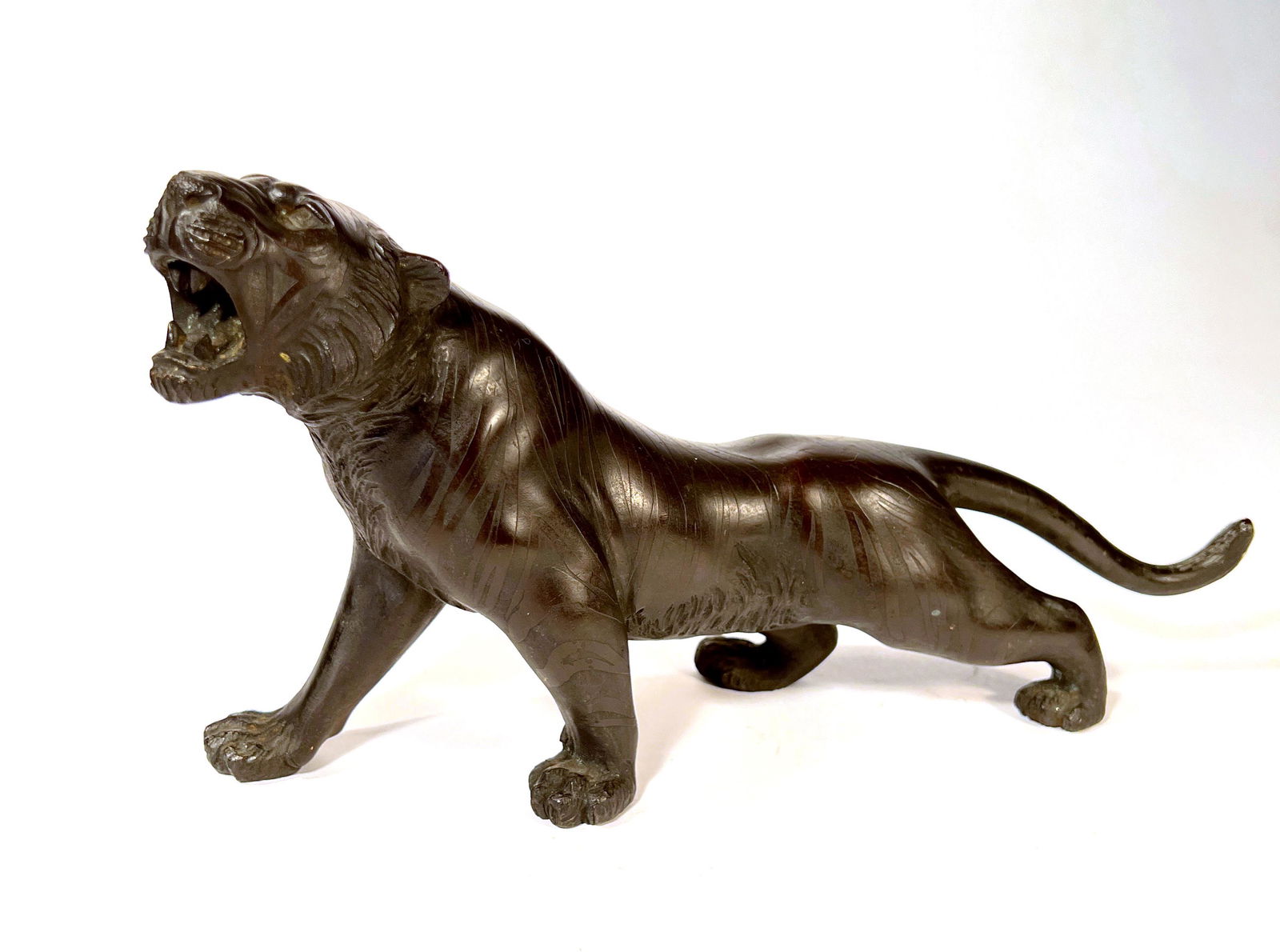 Japanese Meiji Period Bronze Tiger, signed: Japanese Meiji Period Bronze Tiger, signed on belly and in original patina. Appx. 11" long x 5 1/2" tall,