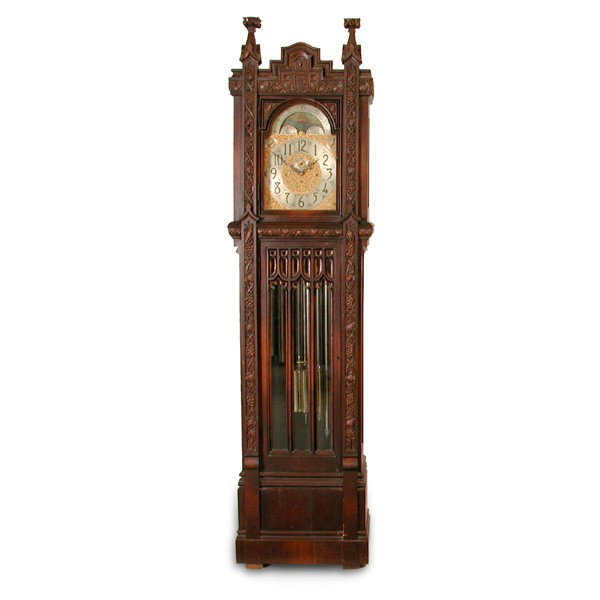 Herschede Gothic Cased Tall Clock: TALL CLOCK. Herschede tall clock having gothic style case surmounted with carved crown, Westminster, Whittington, and Canterbury chimes, with moon phase calendar dial, relief carved birds and floral b