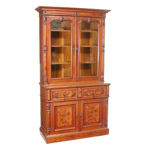 American Victorian Walnut Butler's Desk: DESK. American Victorian walnut butler's desk, having molded cornice, relief carved accents, spoon carved burl panels, the glass paneled cabinet above a drop front desk surface, two drawers and double