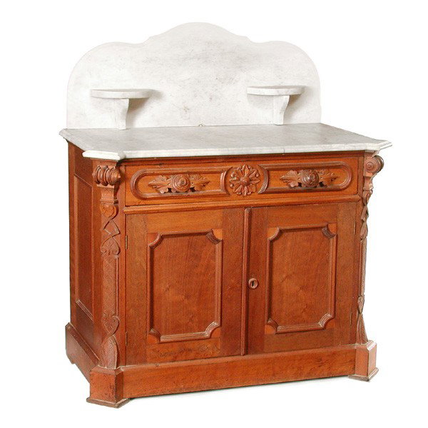 American Victorian Walnut Marble Top Commode: COMMODE. American Victorian walnut marble top commode having shaped back splash, canted corners with carved details, central rosette medallion carving and double doors, 41"h x 37"w x 20"d. In very goo