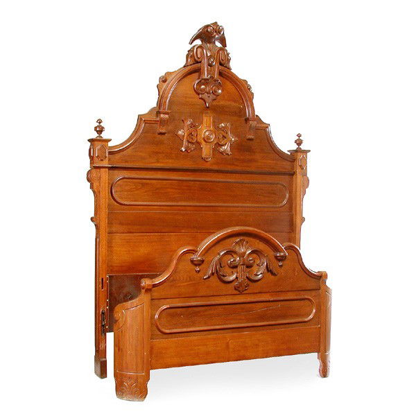 American Victorian Walnut Bed: BED. American Victorian walnut double size bed having carved crest and demilune pediment, the headboard flanked with turned finials, applied foliate carved decorations, headboard 88"h x 62"w. In very