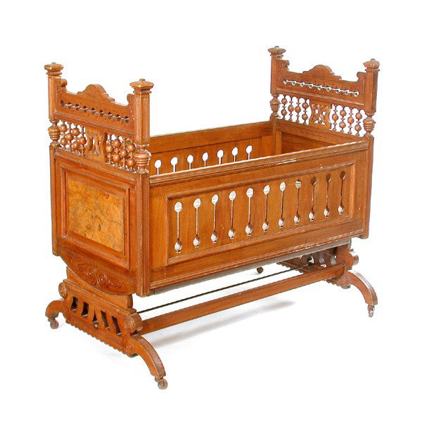 American Eastlake Walnut Stick and Ball Crib: CRIB. American Victorian Eastlake walnut stick and ball child's crib, with turned open gallery, pierced sides and burled panels, with fitted mattress and box spring, 39 1/2"h x 43"l x 28"w. In very go