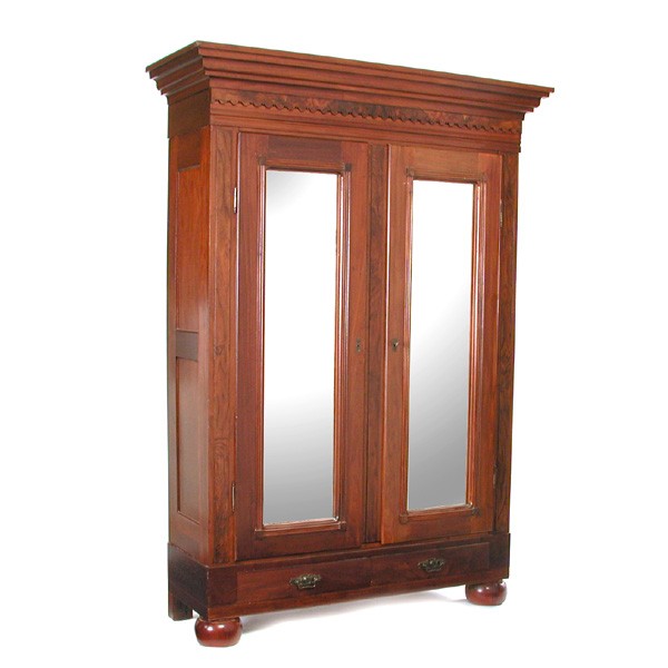 American Victorian Walnut Bookcase: BOOKCASE. An American walnut wardrobe having shaped and tiered cornice, double mirror paneled doors, two lower drawers, the whole rising on bun feet, 83"h x 58 1/2"w x 21"d. In good condition.
