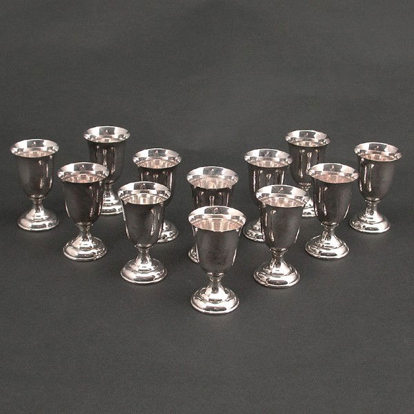 12 Sterling 950 Silver Small Cordial Glasses: CORDIALS. Set of 12 sterling 950 silver small cordials. Marked "Sterling 950" on base. Each measure 2 1/2"T by 1 3/8" across. One of the 12 is has a small crease to the rim, all others in good conditi