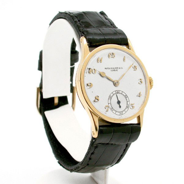 18 Karat Gold Patek Philippe Watch: WATCH. 18 karat yellow gold Patek Philippe watch, leather strap, movement #806372, case #294172, good running condition.