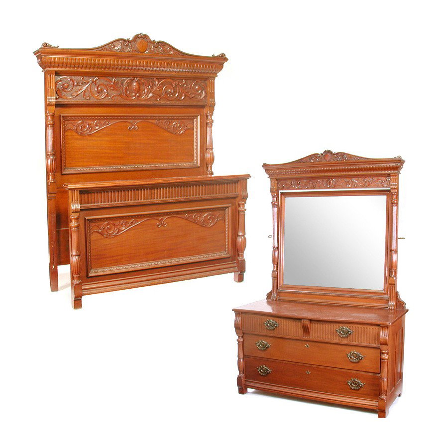 American Mahogany Bedroom Set: BEDROOM SET. Mahogany bedroom set including bed and dresser, both with bowed crest decorated with carved acanthus leaf and shield form reserve center, flanked with fluted columns, the dresser with bev