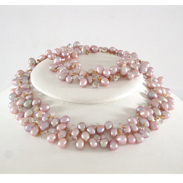 Morganite Briolette & Natural Pink Pearl Necklace: NECKLACE. Natural pink pearl pearls, morganite briolette, 18 karat yellow gold beads with a ruby-set clasp.