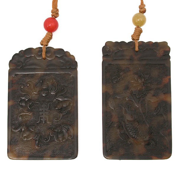 Two (2) Chinese Tortoise Shell Pendants: PENDANTS. Two (2) Chinese Tortoise Shell Pendants each of rectangular shape one carved with shou character encircled by five bats, the other carved with a leaping fish in a lotus pond, length 3.1 inch