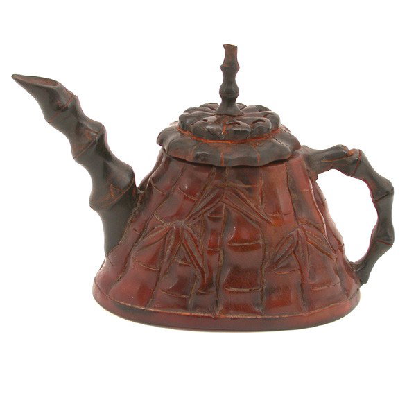 Carved Rhinoceros Horn Teapot, 19th c: TEAPOT. Carved Rhinoceros Horn Teapot, 19th c. The oval shaped body carved in the shape of bamboo with branches forming the spout and handle, the horn of rich brown color with darker inclusions, heigh