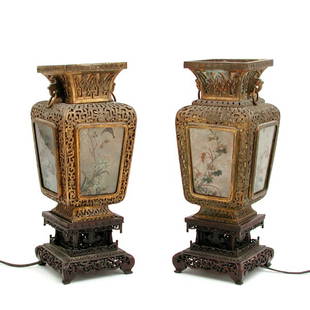 Pair of Chinese Urn Lamps on Wood Bases, 14 1/2"t: LAMPS. Pair of Chinese Urn Lamps on Wood Bases, each openwork brass urn has 4 mica panels with floral and bird scenes that glow when lit, both mounted on ornately carved wooden bases, electrified, 14