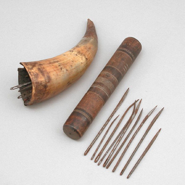 Needle Case and Needle holder: LOT. Sailor's turned wooden needle case with ring decoration and 9 needles, 7 5/8" long, accompanied by a wax filled horn receptacle for sailor's needles, 6 1/2" long.