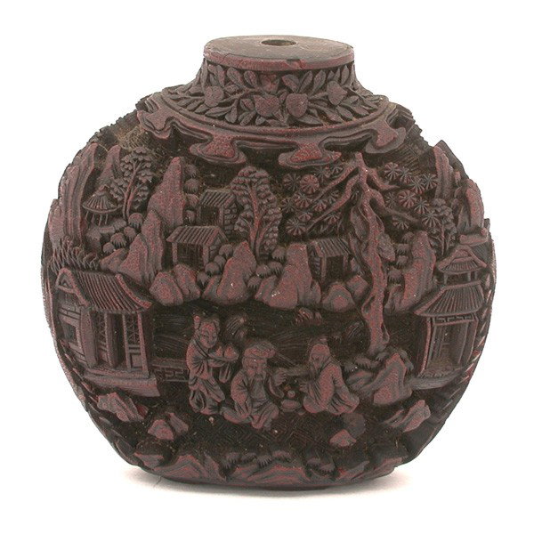 Carved Cinnabar Snuff Bottle: SNUFF BOTTLE. Carved cinnabar snuff bottle. Finely carved with scholars and attendants in landscape setting, 3.1" h.