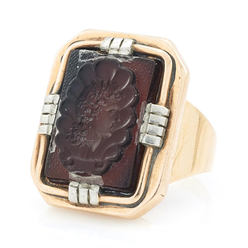 14k Yellow gold intaglio ring with white gold prongs: 14k Yellow gold intaglio ring with white gold prongs, an appx. 13mm x 18mm reddish brown intaglio, size 9.5, 9.3g. Minor losses to intaglio at connection points with fasteners on all 4 sides as shown.