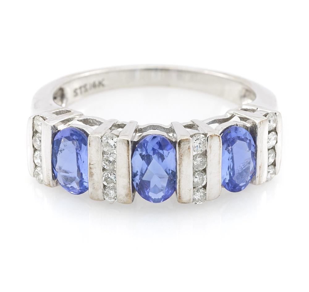 14k White gold, tanzanite, and diamond ring: 14k White gold, tanzanite, and diamond ring, three appx. 4mm x 6mm channel set tanzanite and sixteen channel set 0.01ct diamonds, size 7.25, 3.9g.