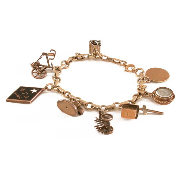 14K Gold Charm Bracelet with Enamel Charms: BRACELET. 14kyg charm bracelet, circa 1930s, with nine charms including a telephone, bicycle, church, cross, fraternity charm, owl and more.