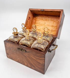 Six bottle tantalus in original mahogany fitted box: Six bottle tantalus in original mahogany fitted box. Bottles with starburt stoppers and original gilt detailing. Box measures appx 8 1/2"T x 10"W x 7"D, bottles measure appx 7 1/2"T. One broken stoppe