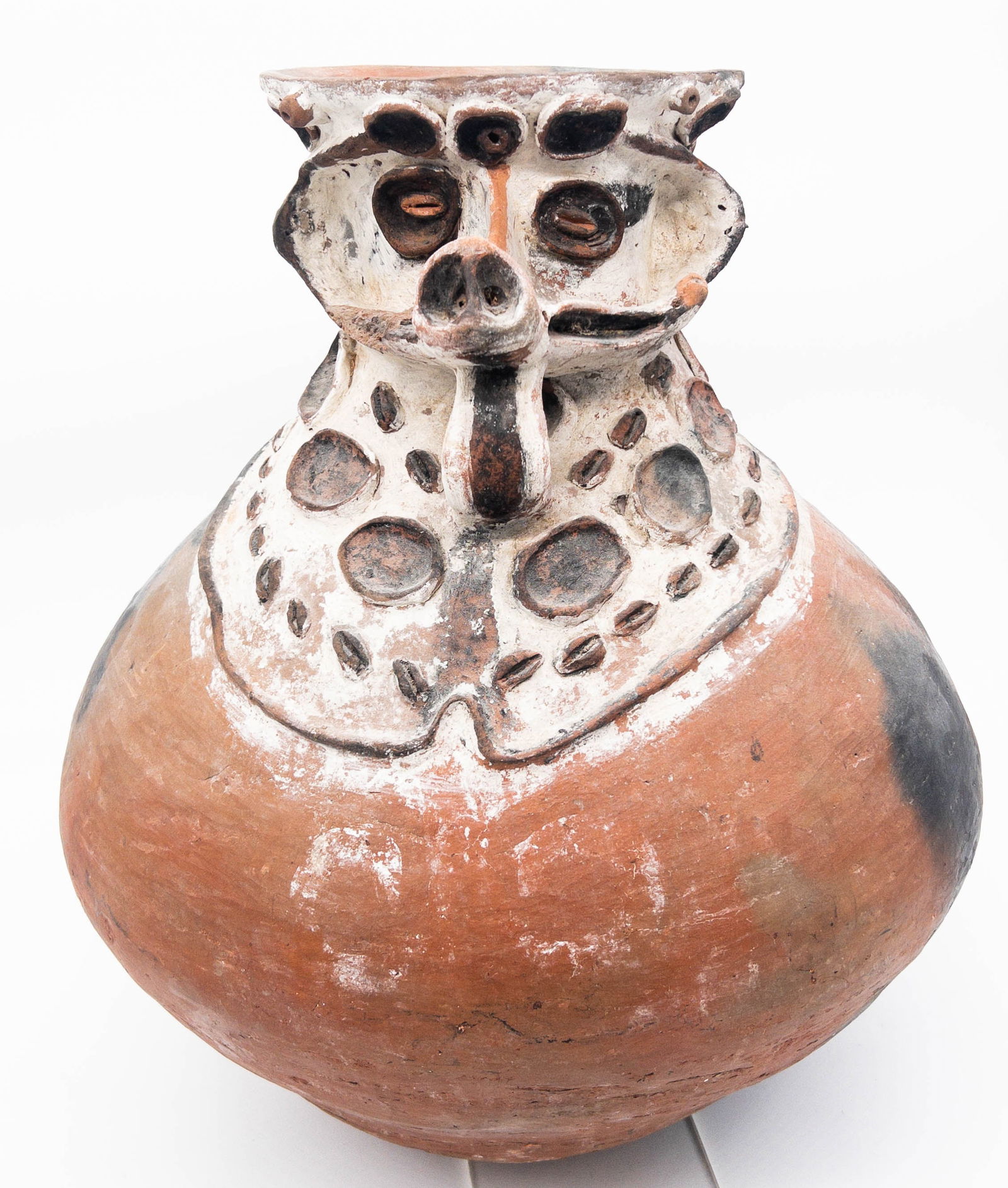 Aibom Pot (Chambri), Sepik River, Papua New Guinea: Aibom Pot (Chambri), Sepik River, Papua New Guinea. Terra Cotta, Kaolin. This is a storage pot featuring a warthog for a face, with a large belly that tapers upwards to the vessel's neck and head. The