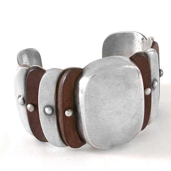 Spratling Silver & Exotic Wood Cuff Bracelet: BRACELET. William Spratling large cuff bracelet of alternating crescents of rosewood and silver around a silver center rectangle, circa 1941-1946, hallmarked "Spratling Made in Mexico", 1 1/2" wide at