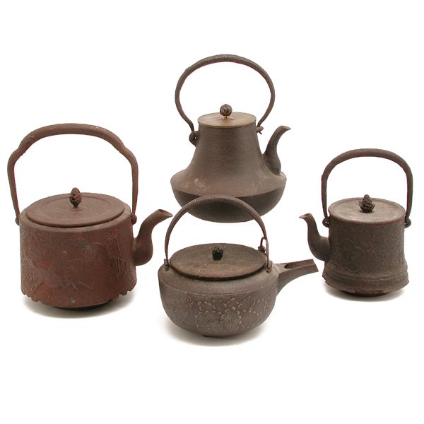 4 Japanese Iron Teapots: TEAPOTS. Lot of 4 Japanese iron teapots, to include: one with embossed horse and mountain design, signed "Gyokuho", 11" h with handle; one with shaped body, 9.25" h with handle; one with floral and le