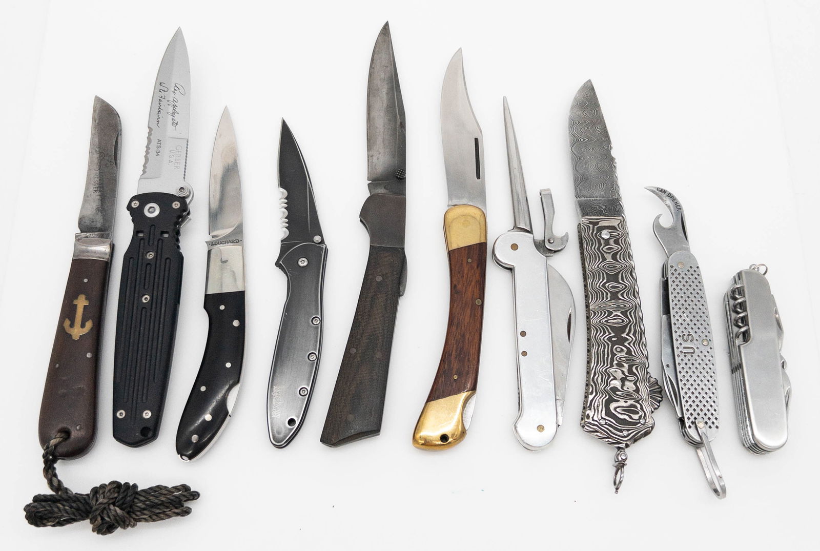 Lot of 10 Mixed Folding Knives: Lot of 10 Mixed Folding Knives to include an Applegate Fairbairn Gerber knife, Lowen Messer anchor knife, Louchard folding knife, Damascus knife, BJ knife with micarta handle, Rostfre wine opener knif