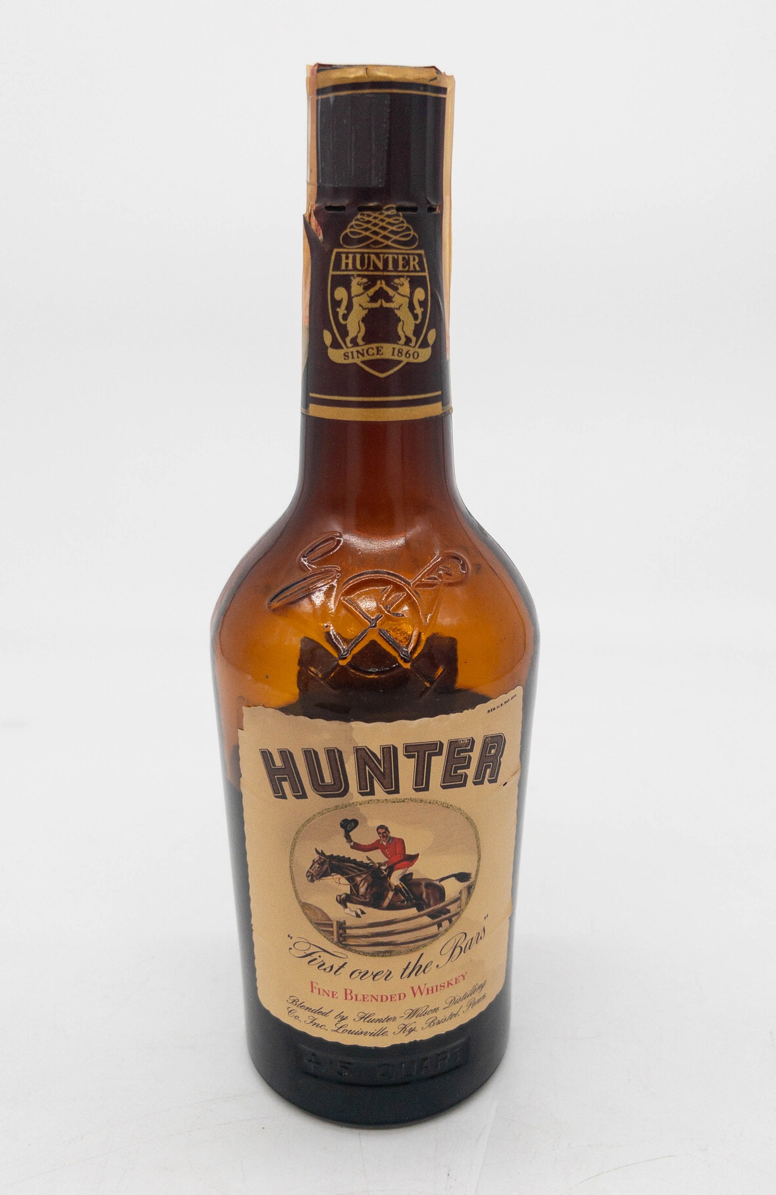 Hunter Kentucky Fine Blended Whiskey: Hunter Fine Blended Whiskey. 86.8 proof, 4/5 qt. Tax strip intact, decorative seal with breaks. Low shoulder.