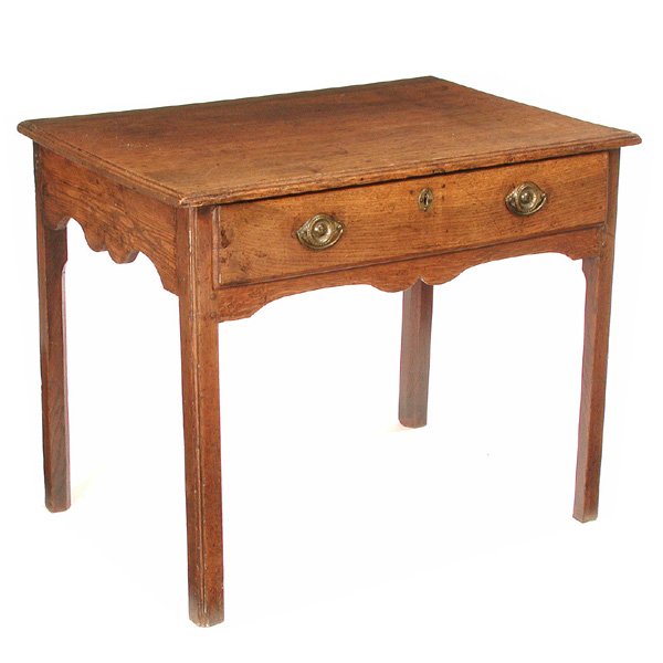 English Writing Table 18th/ 19th c: Writing Table, 18/19th c, English, oak writing table with frieze drawer having round escutcheons and bail handles, above waved kneehole on quadrangular legs, 27"h x 32"w, 22 3/4" d, good condition.