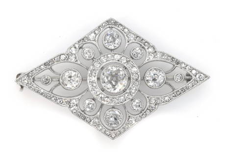 14k White Gold and Diamond Brooch: 14k White Gold and Diamond Brooch. The brooch itself in a diamond shape motif, features an appx 0.50ct center old mine cut diamond surrounded by a circle of smaller round diamonds. Extending from