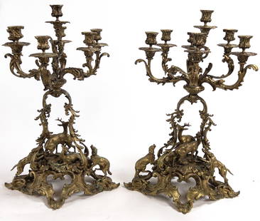 Pair of Monumental Bronze 7 Light Candelabra Hounds, Deer Hunt: This extraordinary pair of monumental bronze 7 light candelabra feature massive open works scroll bodies with a buck and fawns sheltered in the center and two hounds on the hunt coming from each side.