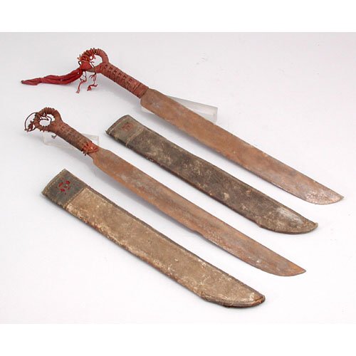 Pair Of African Machetes.: MACHETES. Pair of late 19th C. African Machetes with scabbards and rope bound handles. 24" long. In fair condition.