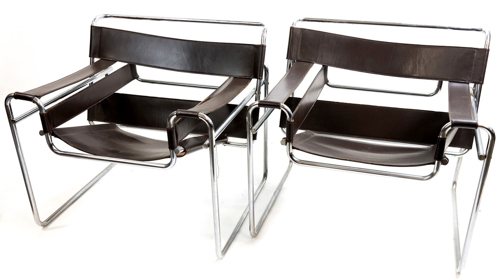 Pair Signed Stendig Marcel Breuer Wassily Lounge Chairs: Pair Signed Stendig Marcel Breuer Wassily Lounge Chairs. In brown leather. Seat of one chair needs repair as shown as well as one leather arm strap on other chair. Makers stamp under seat. Measure app