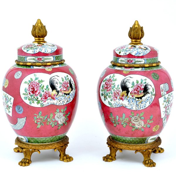 Pair of French Porcelain Urns, 17 1/2": Pair of French Porcelain & Gilt Bronze Covered Urns, with floral and bird decorations on a rich red colored body, and french ormolu accented domed lids with vegetable shaped finials, resting on a claw