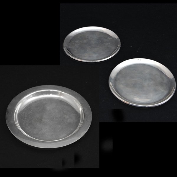 Lot of Sterling Silver Wine Coasters: Lot of Sterling Silver Wine Coasters comprised of: Tiffany Studios coaster, stamped "Tiffany Studios New York 1749", weighs approximately 10.55 ozt, 7 1/4" diameter. Pair of wine coasters "Sterling 92