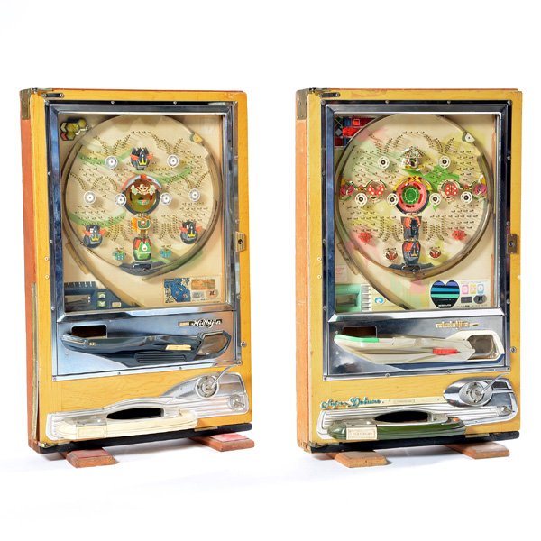 Pair of Japanese Pachinko Machines: Pair of Japanese Pachinko Machines, Nishi-Jin brand, mid 20th century, a vertical pinball-like game stands upright on plank feet, includes metal balls, 32 3/4"h x 20 5/8" w x 8 1/2" d.