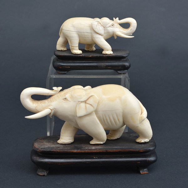 Pair of Chinese Elephant Carvings: Pair of Chinese Elephant Carvings, nicely carved with trunks facing up, on wood bases, large elephant measures, 4" h x 6 1/2" w x 2 1/2" d (incl. base), small elephant measures, 2 1/2" h x 4 1/8" w x 