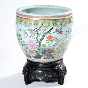 Large Chinese Famille Rose Fish Bowl with Wood Stand: Large Chinese Famille Rose Fish Bowl with Wood Stand, foliate design with branches and birds, atop an ornately carved wood footed stand, 27" h x 20 1/2" d.