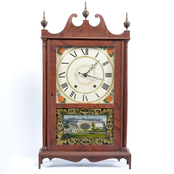 American Pillar and Scroll Eli and Samuel Terry Shelf: 19th C Eli and Samuel Terry, Plymouth Connecticut, mahogany shelf clock with reverse painted glazed door enclosing a pendulum and weights, decorative dial, pillar supports on sides with scroll pedimen