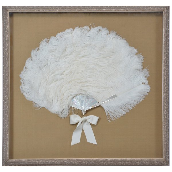 White Ostrich Feather and Mother of Pearl Fan: White Ostrich feather and mother of pearl fan, white ribbon bow to finish, framed in carved wood frame shadow box, 30" x 31 1/4" (frame), good condition.