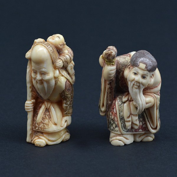 Pair of Japanese Netsuke Carvings, Scholars: Pair of Japanese Netsuke Carvings consisting of: (1) colorfully decorated bearded wiseman holding a child on his back, (2) colorfully decorated bearded wiseman with hat and staff, both are signed at b