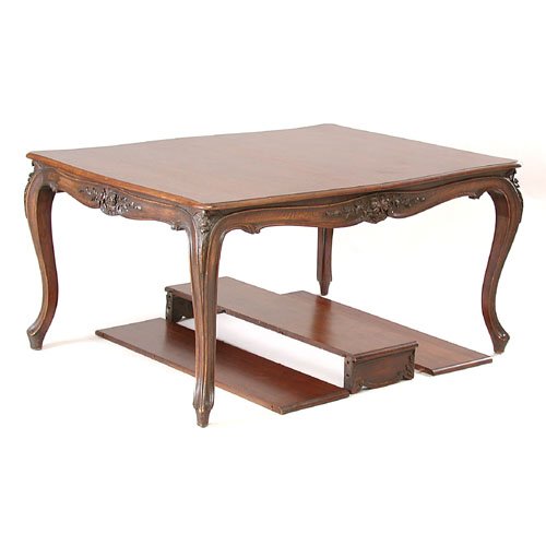 Louis XVI Style Dining Table: DINING TABLE. Early 20th C. Walnut Louis XVI style dining table, floral relief carving with three 12" inserts (one with skirt). 60" x 42" x 26". Very good condition.