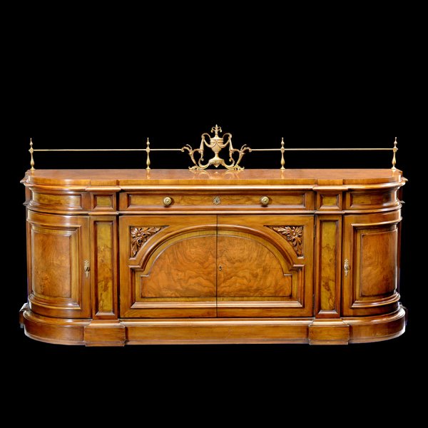Karges Walnut and Brass Buffet: Karges walnut and brass buffet, shaped cabinet with brass gallery and urn center detail, single drawer above 2 door center cabinet and corner compartments on either side, manufacturer's label inside d