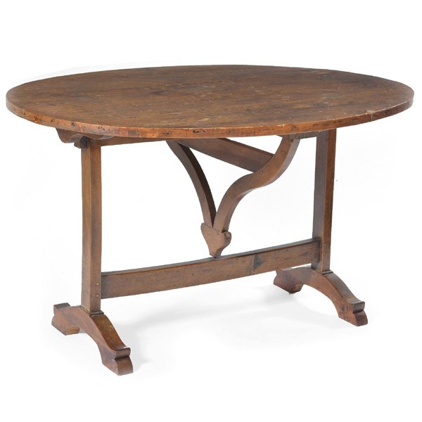 French Wine Tasting Table, 18th/19th C: 18th/19th c French wine tasting table, oval tilt top above swing out support, raised on a trestle base, 30" h x 51" w x 38 1/2" d, good condition, wear typical of use and age.