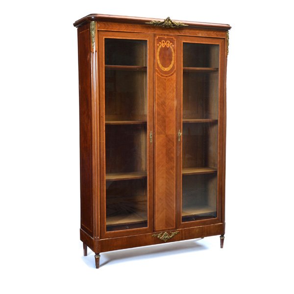 French Walnut Vitrine: French walnut glazed 2 door vitrine with ormolu mounts, inlaid multiwood decoration and ribbon and wreath detail, adjustable wood shelves interior, 88 1/2" h x 56" w x 20" d, good condition.