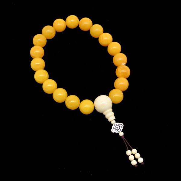 Chinese Amber Buddhist Prayer Beads: Chinese amber Buddhist prayer beads, comprising of 19 semi-translucent spherical beads of golden yellow color suffused with white and light brown swirls, 13" (overall length).